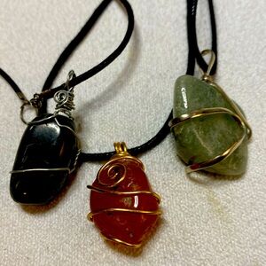 Bundle of 3 natural gemstone necklaces on black cords.
